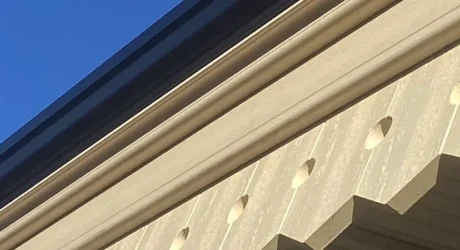 A hot air balloon flies over a cream heritage station canopy at bath spa made from composite material.